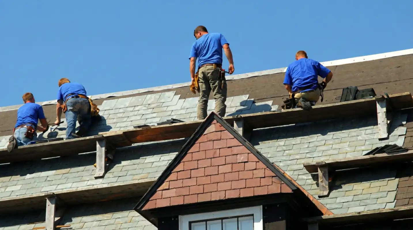 Roof replacement in progress with a team of professional contractors installing new shingles on a residential home in San Antonio, TX